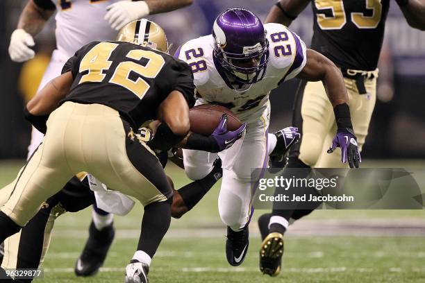 Adrian Peterson of the Minnesota Vikings runs the ball against the New Orleans Saints during the NFC Championship Game at the Louisiana Superdome on...