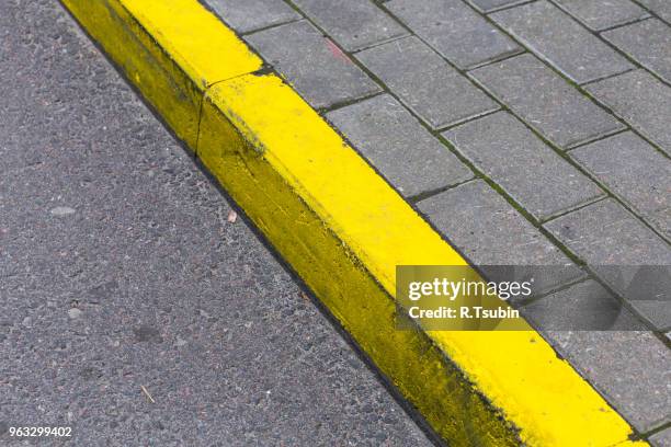yellow kerb line on the asphalt road - curb stock pictures, royalty-free photos & images