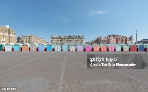 a row of multi-coloured beach huts along the promenade, hove, uk - promenade seafront stock pictures, royalty-free photos & images