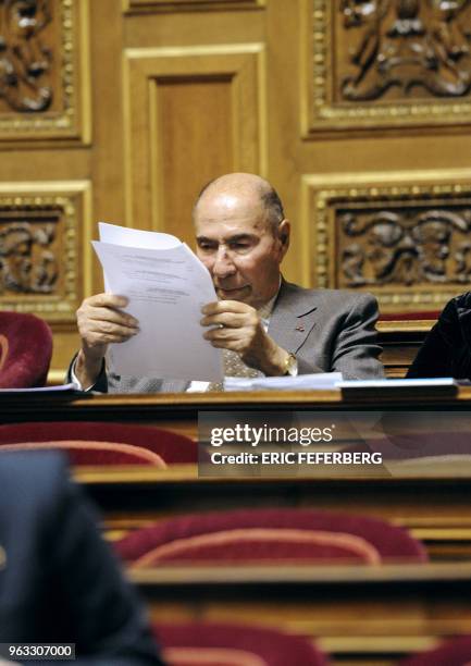 France's UMP ruling party senator Serge Dassault reads a document as he attends the French Senate vote session for a bill criminalizing the denial of...