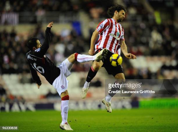 Matthew Etherington of Stoke City competes for the ball with Lorik Cana of Sunderland during the Barclays Premier League match between Sunderland and...
