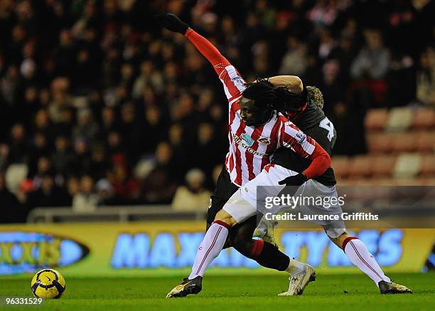 Robert Huth of Stoke City tangles with Kenwyne Jones of Sunderland during the Barclays Premier League match between Sunderland and Stoke City at the...