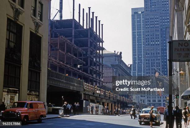 New York City - People out and about on Vanderbilt Avenue in Midtown Manhattan. At left is the Pan Am Building construction site.