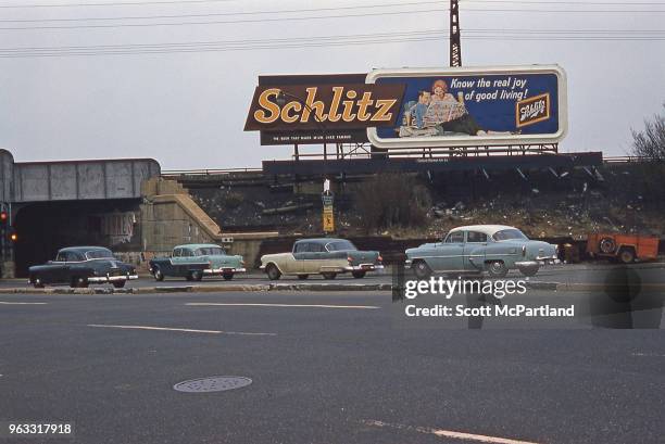 New York City - Cars on Woodhaven Boulevard drive past a Schlitz beer billboard in Queens, New York.