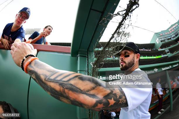 Blake Swihart of the Boston Red Sox signs autographs before game against the Atlanta Braves at Fenway Park on May 26, 2018 in Boston, Massachusetts.