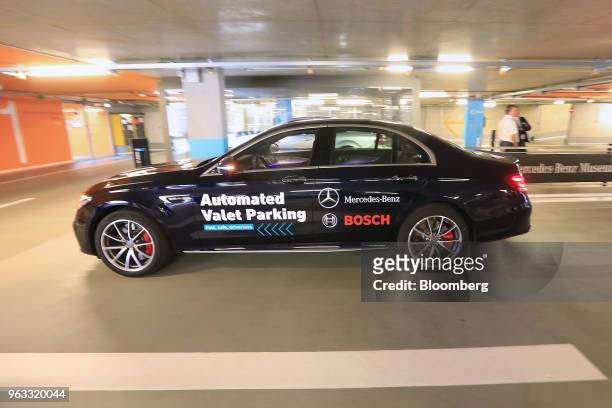 Driverless Daimler AG Mercedes-Benz AMG E63 S automobile maneuvers to a parking space during an Automated Valet Parking demonstration at the...