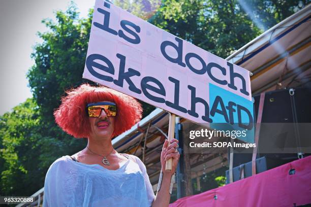 Demonstrator seen holding a placard during the protest. Techno lovers and anti racism activists have marched in Berlin against a rally organised by...