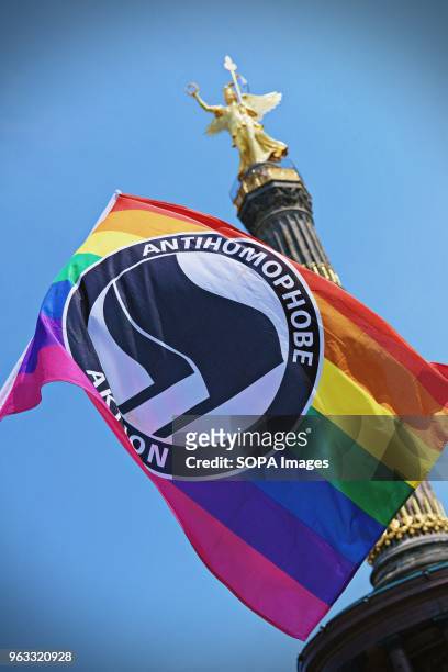 An LGBT flag seen during the protest. Techno lovers and anti racism activists have marched in Berlin against a rally organised by the German...