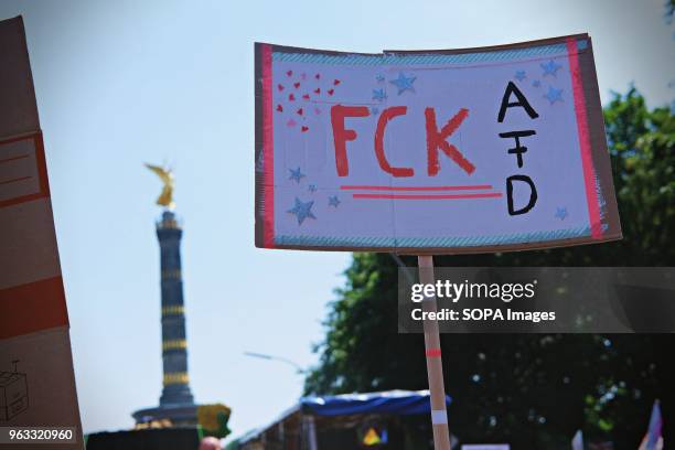Placard writting on it 'FCK AFD' seen during the protest. Techno lovers and anti racism activists have marched in Berlin against a rally organised by...