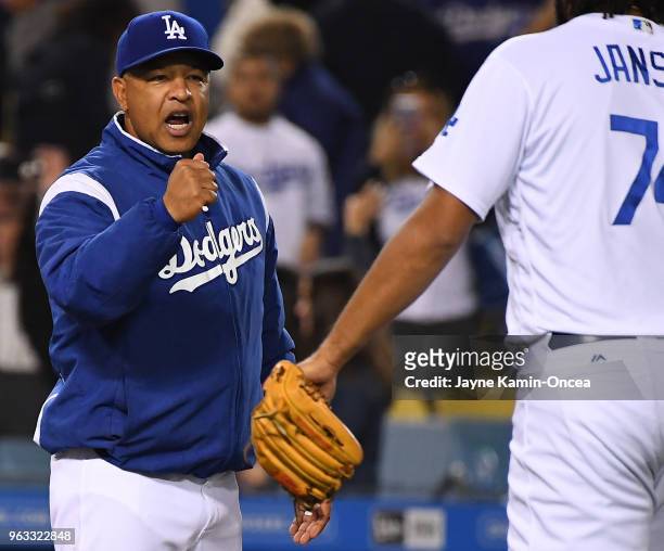 Manager Dave Roberts of the Los Angeles Dodgers greets players after the final out of the game against the Colorado Rockies at Dodger Stadium on May...