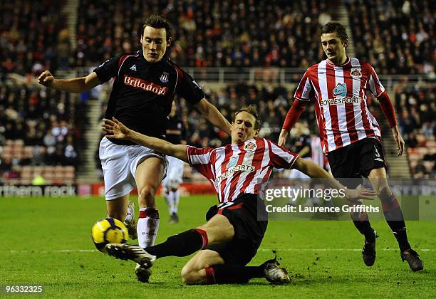 Matthew Kilgallon of Sunderland tackles Dean Whitehead of Stoke City during the Barclays Premier League match between Sunderland and Stoke City at...