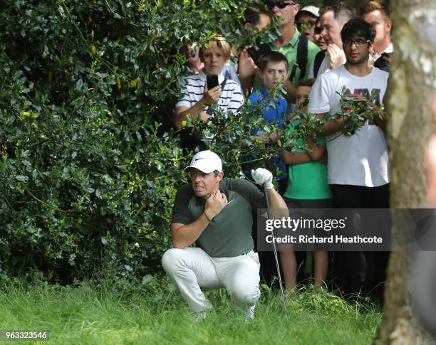 Rory McIlroy of Northern Ireland reacts after hitting a spectator on the 6th hole during the third round of the BMW PGA Championship at Wentworth on...