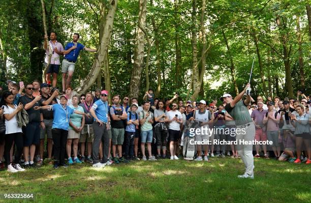 Rory McIlroy of Northern Ireland plays from under the trees on the third hole during the third round of the BMW PGA Championship at Wentworth on May...