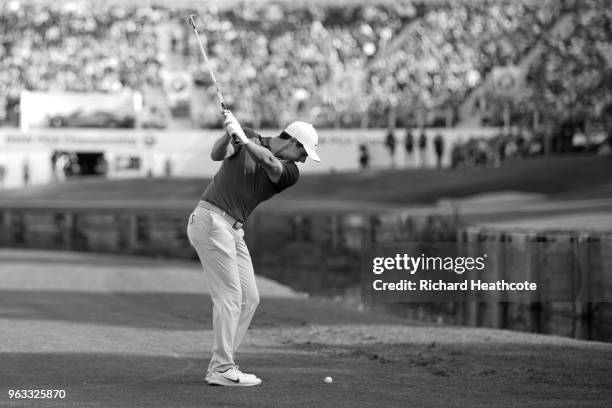 Rory McIlroy of Northern Ireland pitches into the 18th green during the third round of the BMW PGA Championship at Wentworth on May 26, 2018 in...