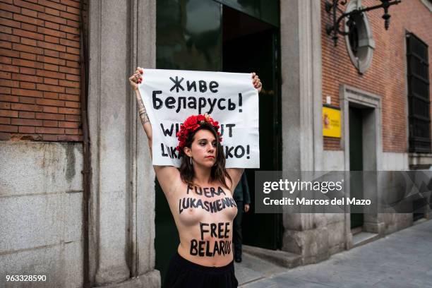 Femen" activist protesting in front of Ministry of Justice on the occasion of the visit of the Belarusian Justice Minister . Activist shows painted...