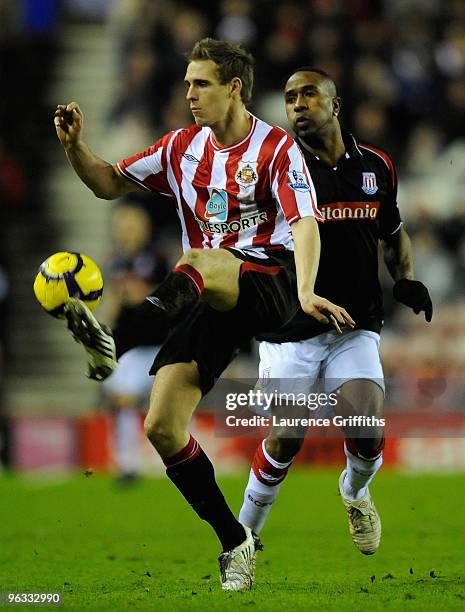 Matthew Kilgallon of Sunderland beats Ricardo Fuller of Stoke City to the ball during the Barclays Premier League match between Sunderland and Stoke...