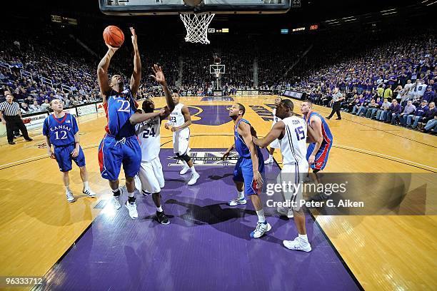 Guard Marcus Morris of the Kansas Jayhawks drives to the basket against pressure from forward Curtis Kelly of the Kansas State Wildcats in the second...