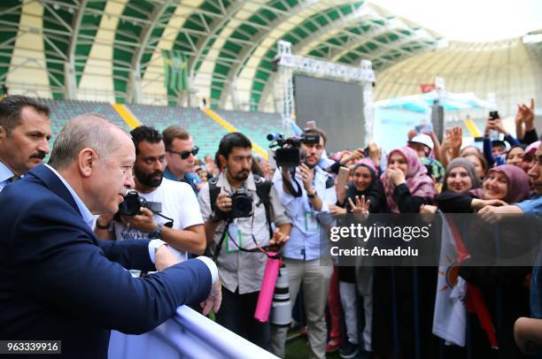 President of Turkey Recep Tayyip Erdogan greets people as he attends the ruling Justice and Development Party rally in western Manisa province of...