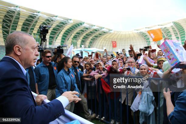 President of Turkey Recep Tayyip Erdogan greets people as he attends the ruling Justice and Development Party rally in western Manisa province of...