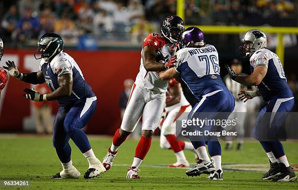 Mario Williams of the Houston Texans in action against Steve Hutchinson of the Minnesota Vikings during the 2010 AFC-NFC Pro Bowl at Sun Life Stadium...