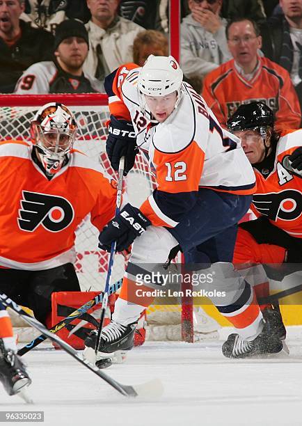 Josh Bailey of the New York Islanders attempts a shot on goal against Ray Emery and Kimmo Timonen of the Philadelphia Flyers on January 30, 2010 at...