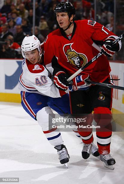 Filip Kuba of the Ottawa Senators skates against Maxim Lapierre of the Montreal Canadiens during a game at Scotiabank Place on January 30, 2010 in...