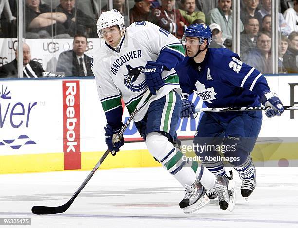 Francois Beauchemin of the Toronto Maple Leafs tracks down Steve Bernier of the Vancouver Canucks during game action January 30, 2010 at the Air...