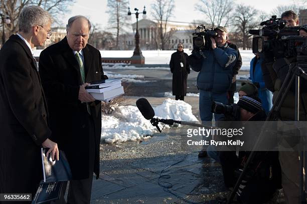 House Budget Committee Chairman John M. Spratt Jr., D-S.C., holds the White House's fiscal 2011 budget for members of the press. At left is the...