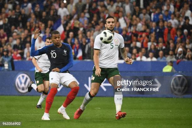 French forward Kylian Mbappe vies with Irish defender Shane Duffy during the friendly football match between France and Ireland at the Stade de...