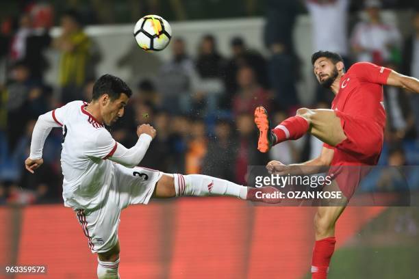 Iran's Ehsan Hajsafi vies for the ball with Turkey's Emre Akbaba during the friendly football match between Turkey and Iran at Basaksehir Fatih Terim...