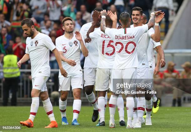 Portugal and AC Milan forward Andre Silva celebrates with teammates after scoring a goal during the International Friendly match between Portugal and...