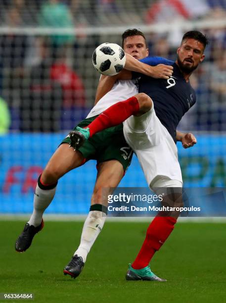 Olivier Giroud of France and Shane Long of Ireland battle for the ball during the International Friendly match between France and Ireland at Stade de...