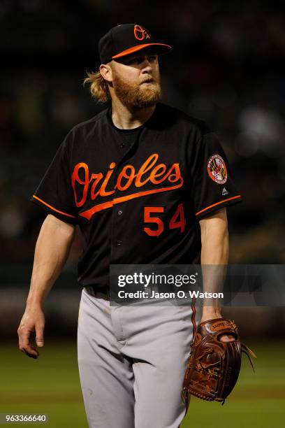 Andrew Cashner of the Baltimore Orioles returns to the dugout after being relieved against the Oakland Athletics during the fifth inning at the...