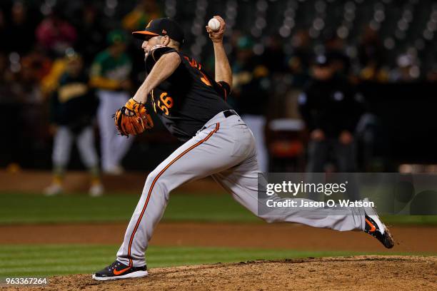 Darren O'Day of the Baltimore Orioles pitches against the Oakland Athletics during the seventh inning at the Oakland Coliseum on May 4, 2018 in...