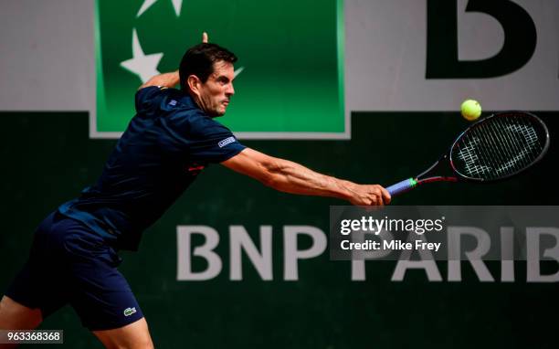 Guillermo Garcia-Lopez of Spain hits a backhand to Stan Wawrinka of Switzerland in the first round of the men's singles during the French Open at...