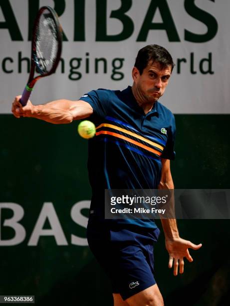 Guillermo Garcia-Lopez of Spain hits a backhand to Stan Wawrinka of Switzerland in the first round of the men's singles during the French Open at...