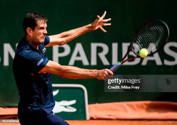 Guillermo Garcia-Lopez of Spain hits a backhand to Stan Wawrinka of Switzerland in the first round of the men's singles during the French Open at...