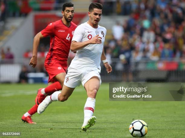 Portugal and AC Milan forward Andre Silva with Tunisia defender Yassine Meriah in action during the International Friendly match between Portugal and...