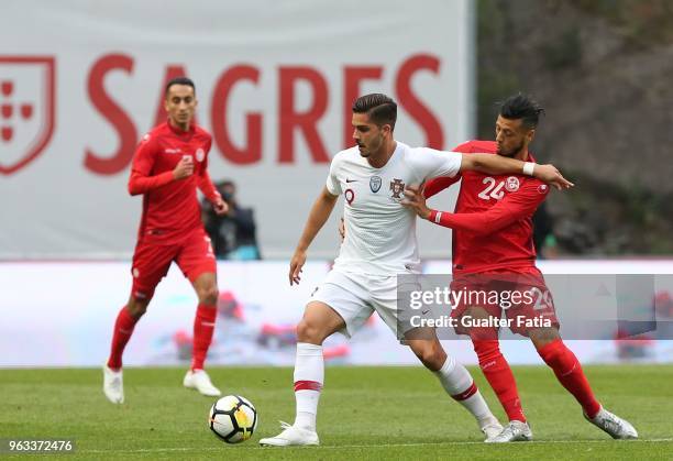 Portugal and AC Milan forward Andre Silva with Tunisia forward Anice Badri in action during the International Friendly match between Portugal and...