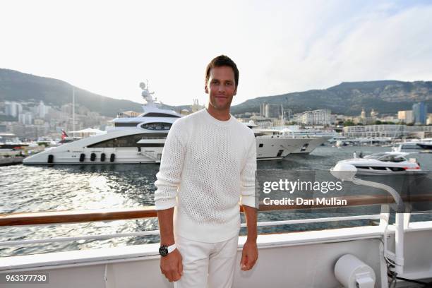 Star Tom Brady poses for a photo after throwing a ball to Daniel Ricciardo of Australia and Red Bull Racing on the TAG Heuer boat after qualifying...