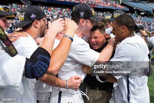 Yale Bulldogs players celebrate with Yale Bulldogs head coach Andy Shay at the conclusion of the NCAA Division I Men's Championship match between...