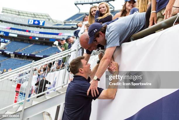 Yale Bulldogs head coach Andy Shay celebrate with fans at the conclusion of the NCAA Division I Men's Championship match between Duke Blue Devils and...