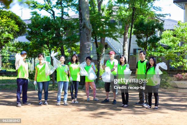 group photo of volunteer group in public park in toyko - environmental cleanup stock pictures, royalty-free photos & images