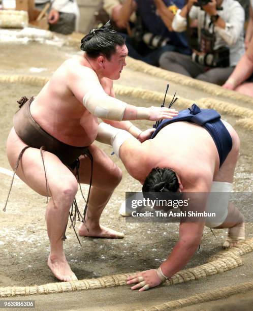 Mongolian yokozuna Hakuho throws Ikioi to win on day thirteen of the Grand Sumo Summer Tournament at Ryogoku Kokugikan on May 25, 2018 in Tokyo,...