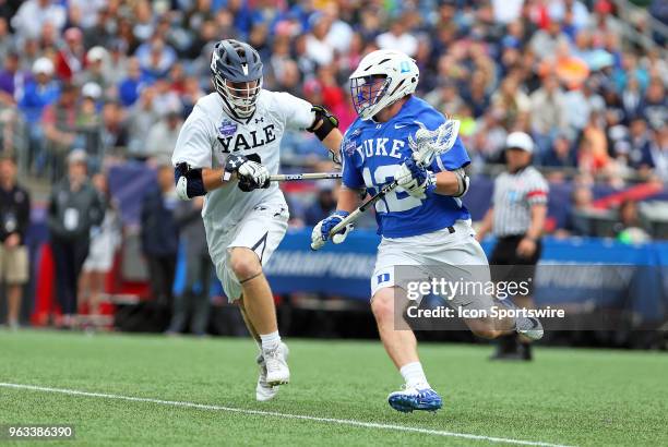 Yale Bulldogs attackman Lucas Cotler pursues Duke Blue Devils midfielder Kevin Quigley during the NCAA Division I Men's Championship match between...