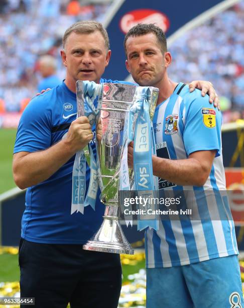 Coventry City manager Mark Robins and Michael Doyle of Coventry City celebrate with the trophy after the Sky Bet League Two Play Off Final between...