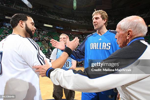 Deron Williams of the Utah Jazz and Dirk Nowitzki of the Dallas Mavericks meet Dick Bavetta at center prior to the game at EnergySolutions Arena on...