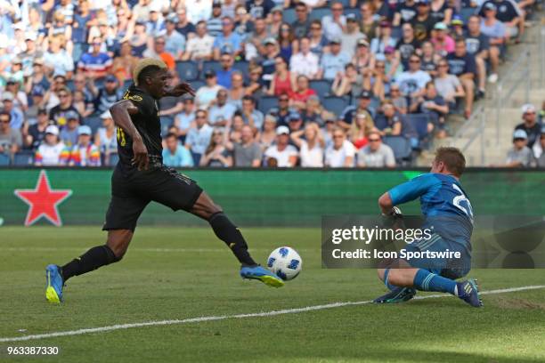 Sporting Kansas City goalkeeper Tim Melia comes off his line to defend Columbus Crew forward Gyasi Zerdes in the first half of an MLS match between...