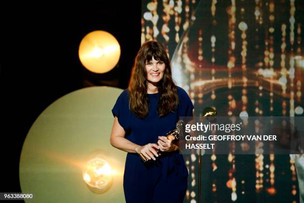 French actress Marina Hands holds her trophy after winning a Moliere award for best actress in "Actrice" during the 30th Molieres French theatre...