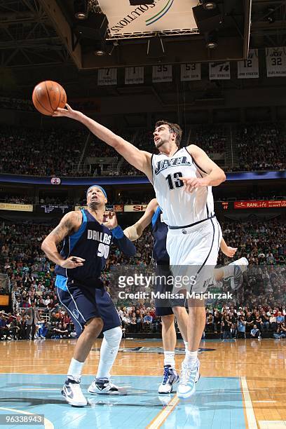 Mehmet Okur of the Utah Jazz goes up for the layup against Drew Gooden of the Dallas Mavericks at EnergySolutions Arena on February 1, 2010 in Salt...